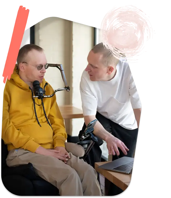 A Man is Briefing to a Disabled man Sitting on Wheel Chair