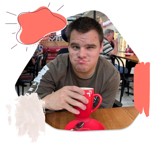 A Disabled Boy is Enjoying Tea in A Cafe